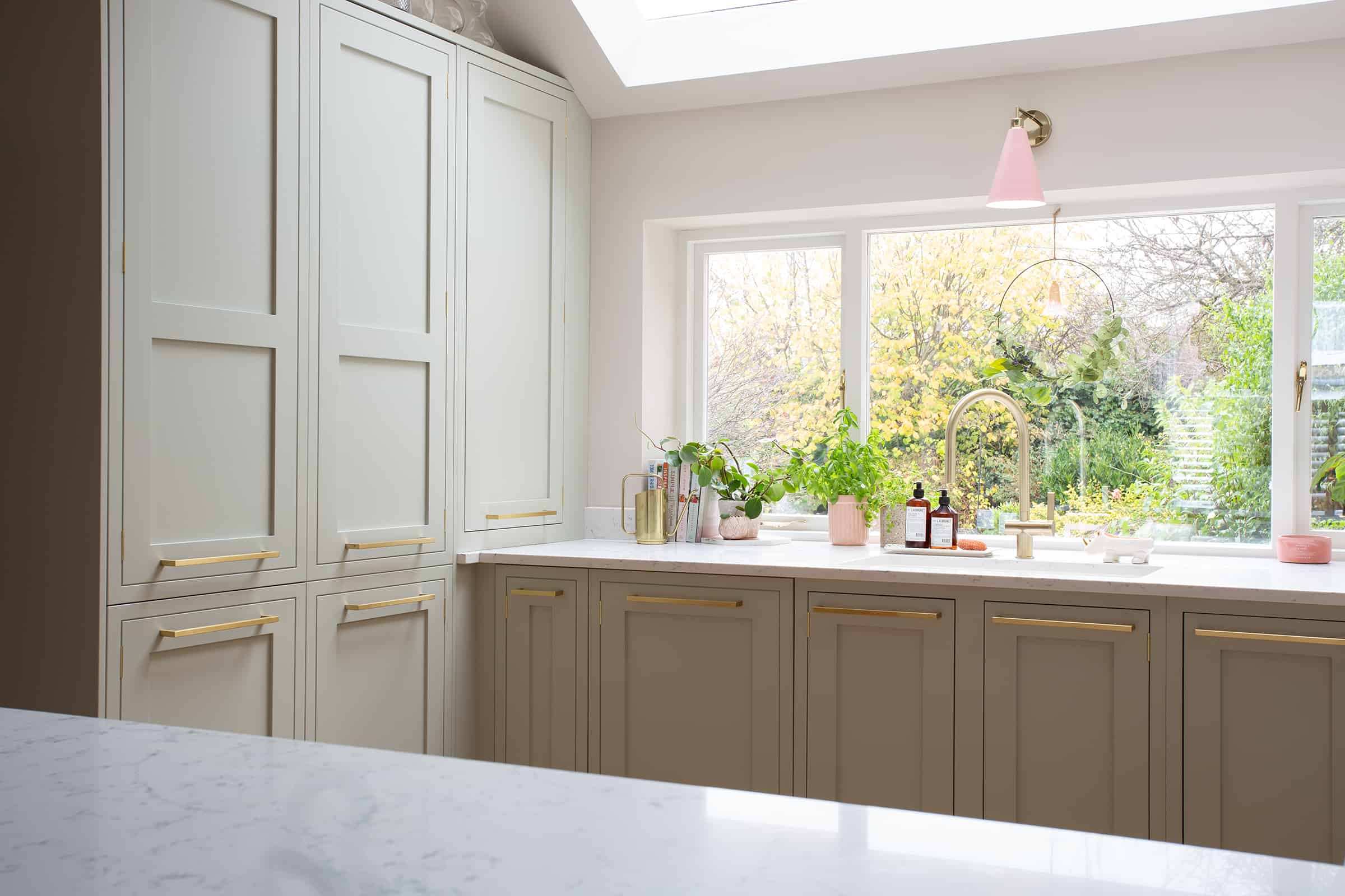 John Lewis of Hungerford swoonworthy luxury shaker style kitchen in soft green with pale pink accent walls with white marble worktops and gold metal handles