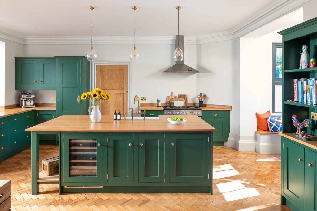 John Lewis of Hungerford luxury shaker kitchen with green cabinetry and wooden worktops