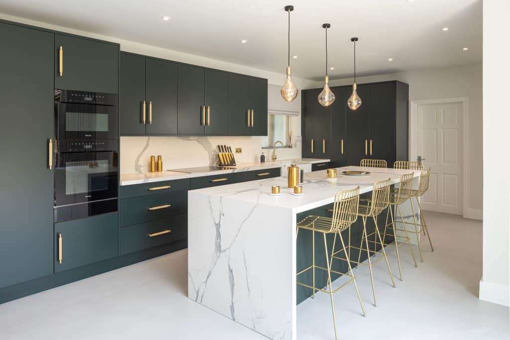 John Lewis of Hungerford kitchen with a marble island in dark green with fitted appliances