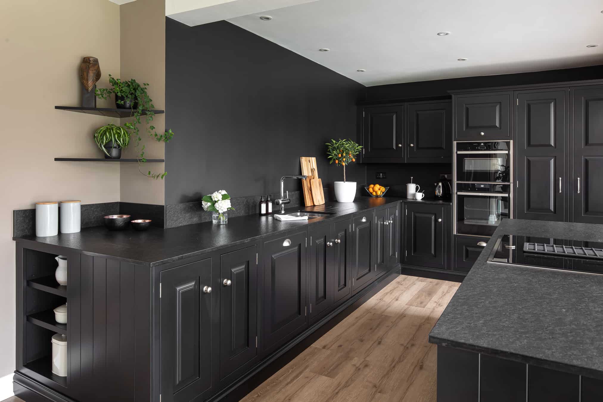 John Lewis of Hungerford luxury bespoke artisan country kitchen with black cabinetry and black granite worktops with wooden floorboards